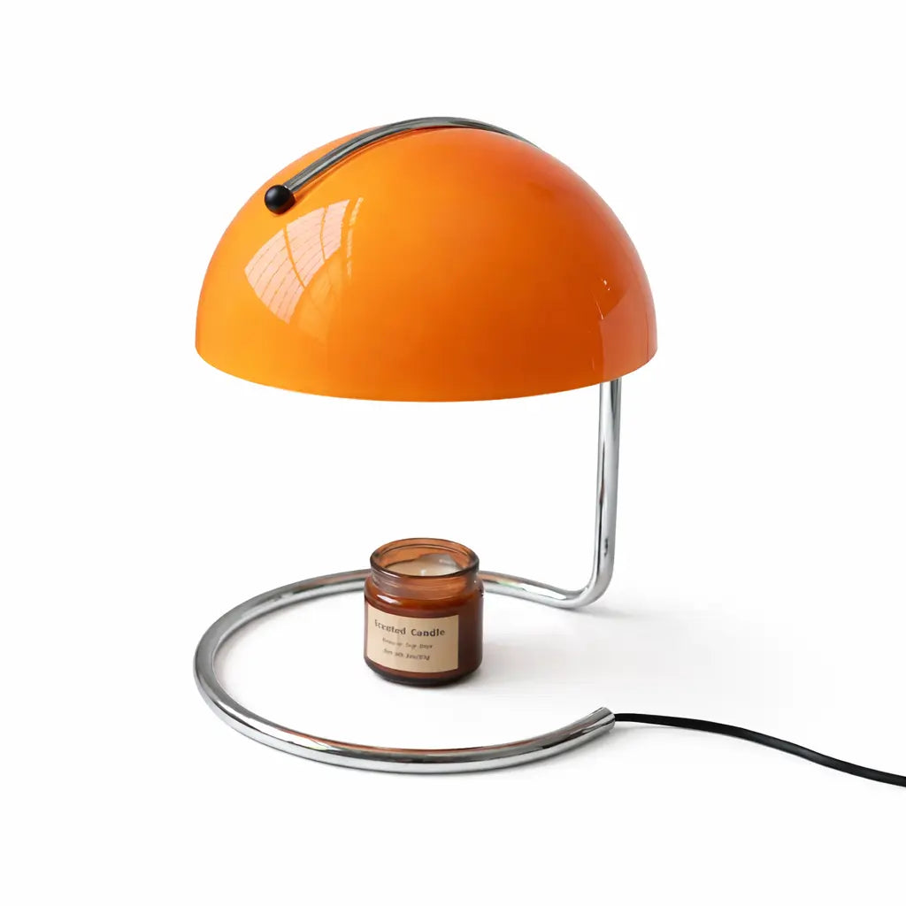 Orange dome candle warmer lamp with chrome C-shaped base and jar candle.