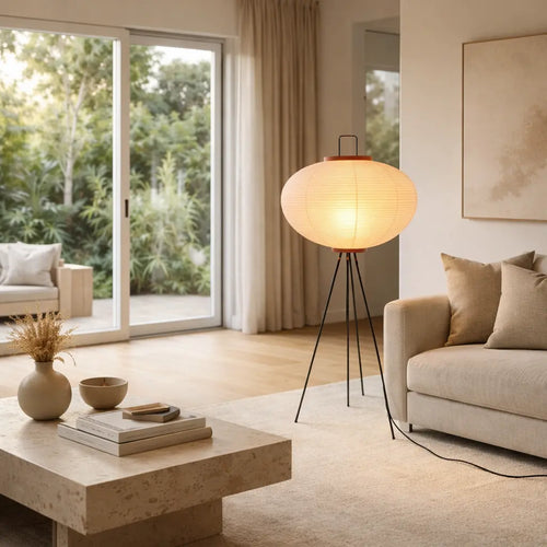 Scandinavian style Japanese paper floor lamp with black tripod base in bright lounge room