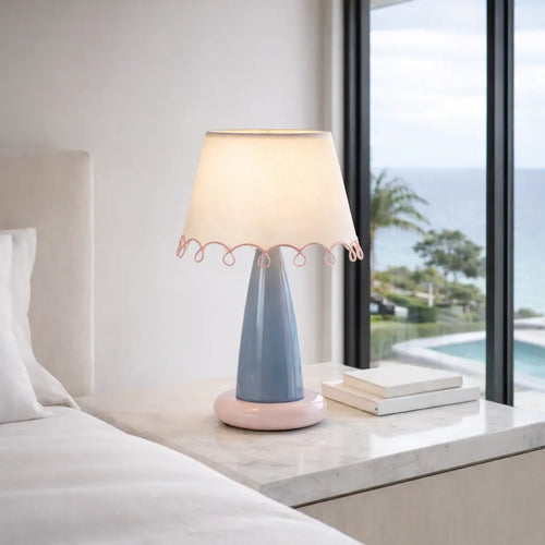 Pastel blue ceramic bedside lamp styled on modern bedroom nightstand
