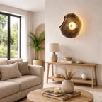 Smoked grey organic glass wall sconce styled in modern living room