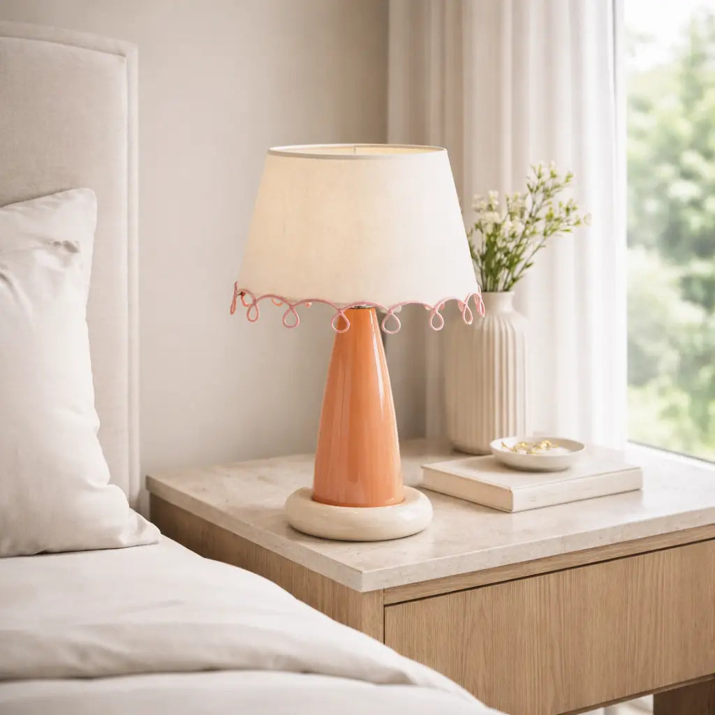Peach ceramic bedside lamp styled on bedroom nightstand