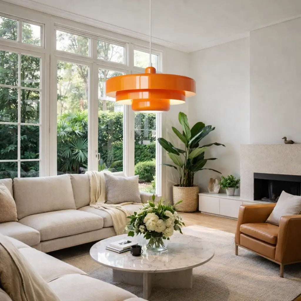 Orange multi-layer ceiling light above a marble table.