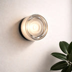 Clear glass round wall sconce with warm white light