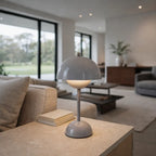 Grey mushroom table lamp on stone side table in contemporary living room