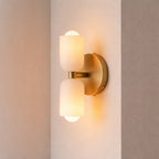 Modern double frosted glass wall sconce switched on with warm ambient light