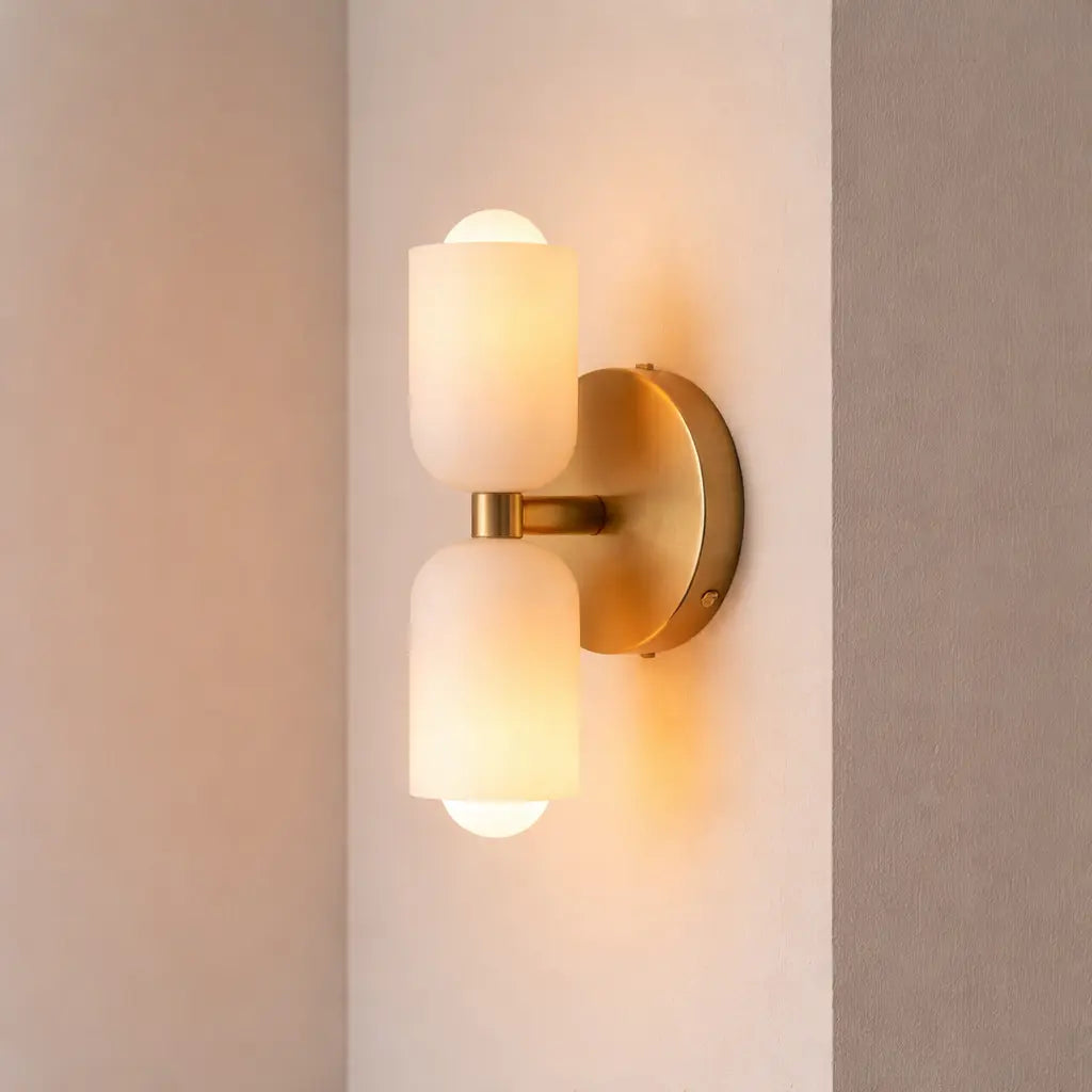 Modern double frosted glass wall sconce switched on with warm ambient light