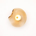 Close-up amber organic glass LED wall light