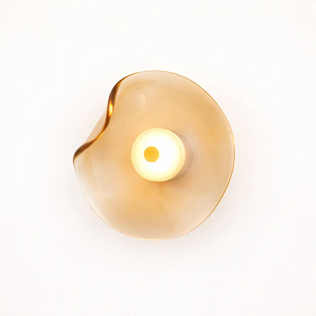Close-up amber organic glass LED wall light